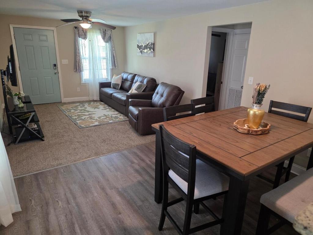 a living room with a table and a couch at Sooner's Retreat in Columbus