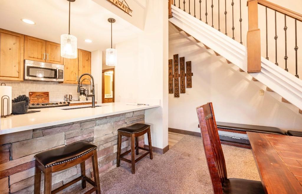 a kitchen with a counter and a staircase at Long Branch #311 in Breckenridge