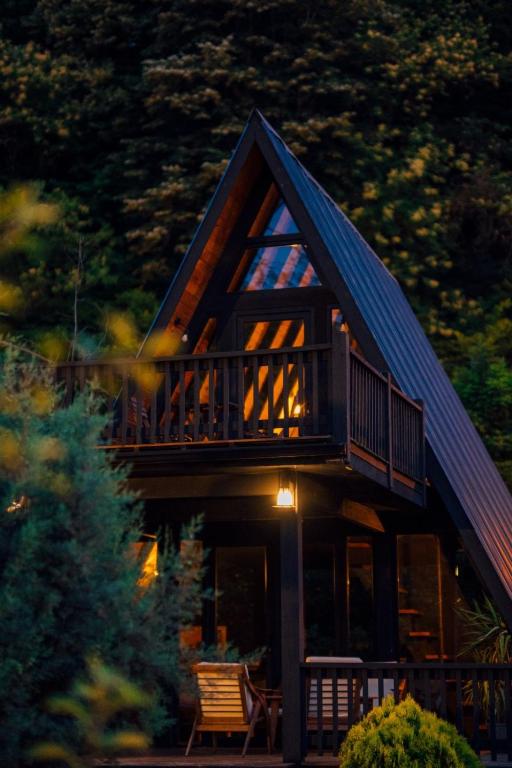 a log cabin with a balcony and a deck at MC Sapanca Hotel in Sakarya