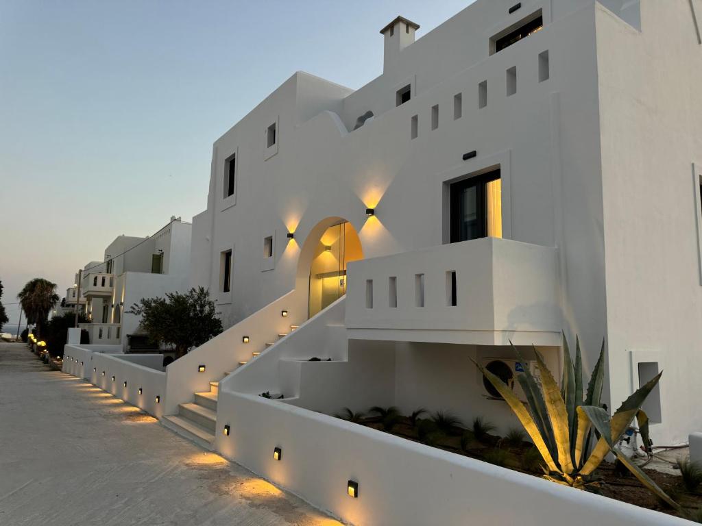 a white building with stairs and lights on it at Olive Garden Hotel in Agios Prokopios