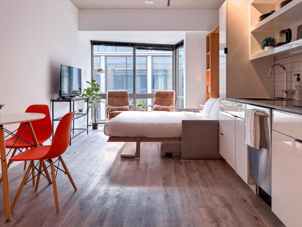 a bedroom with a bed and a table and chairs at City & River View Suite - The Wharf DC by Monthier in Washington