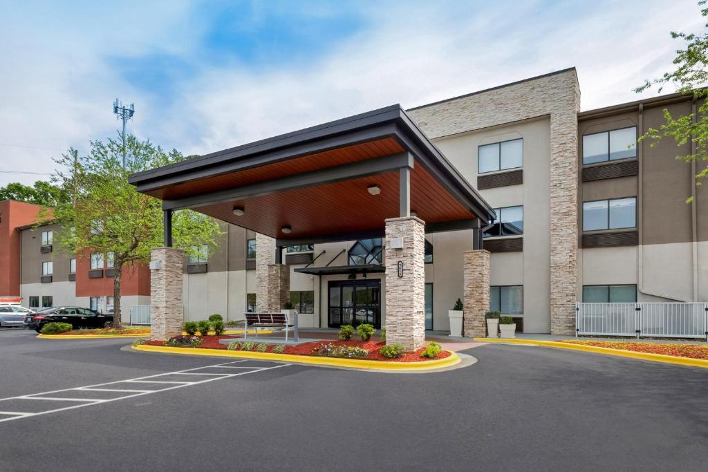 a rendering of a building with awning in a parking lot at Holiday Inn Express & Suites Raleigh NE - Medical Ctr Area by IHG in Raleigh