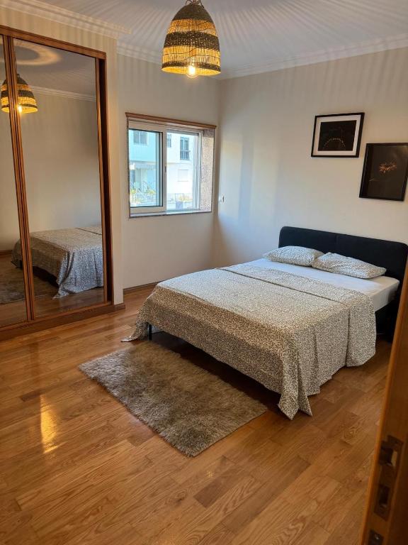 a bedroom with a bed and a large mirror at Hostel Antas Porto in Porto