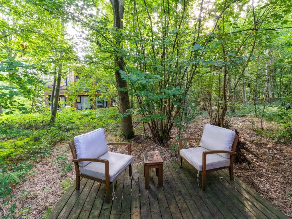 two chairs and a coffee table on a deck at Cottage in Tournai with Forest View in Antoing