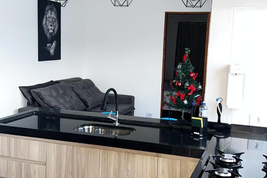 a living room with a christmas tree in the mirror at casa apto inteiro 4 camas 8 km aeroporto Guarulhos in Guarulhos