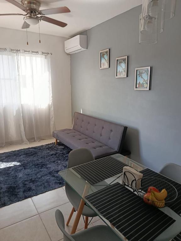 a living room with a table and a couch at Departamento "Mar & Descanso" in Ciudad Madero