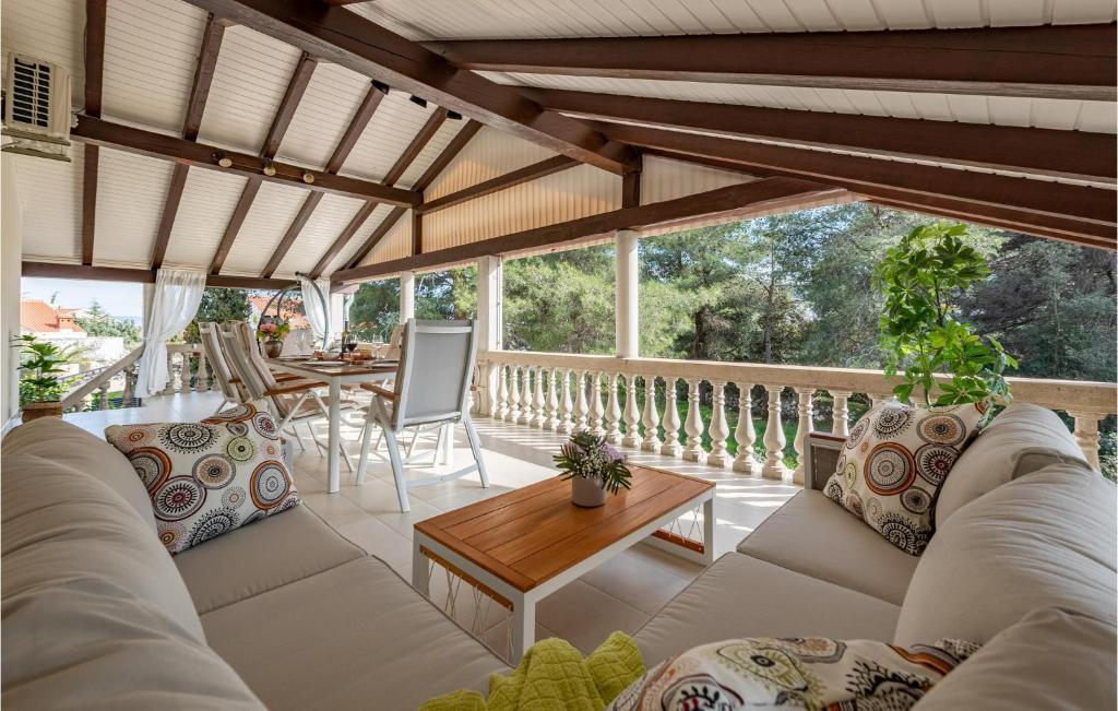 a living room with white furniture and a balcony at 3 Bedroom Beach Front Home In Zdrelac in Ždrelac
