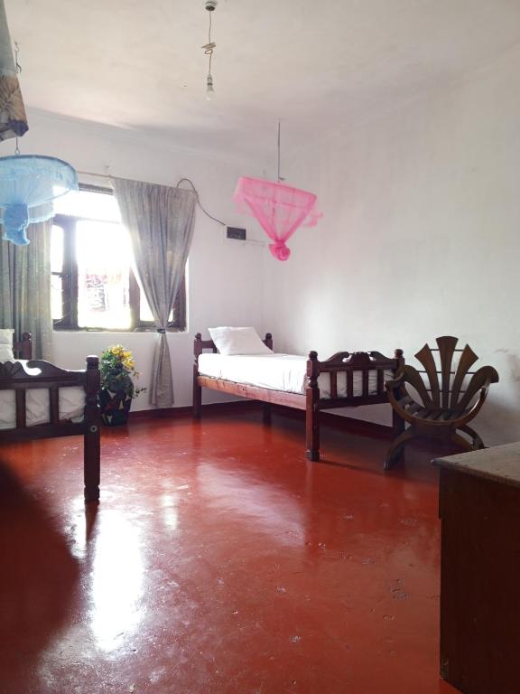 a bedroom with a bed and a pink umbrella at Kandy Nest Stay Home in Kandy