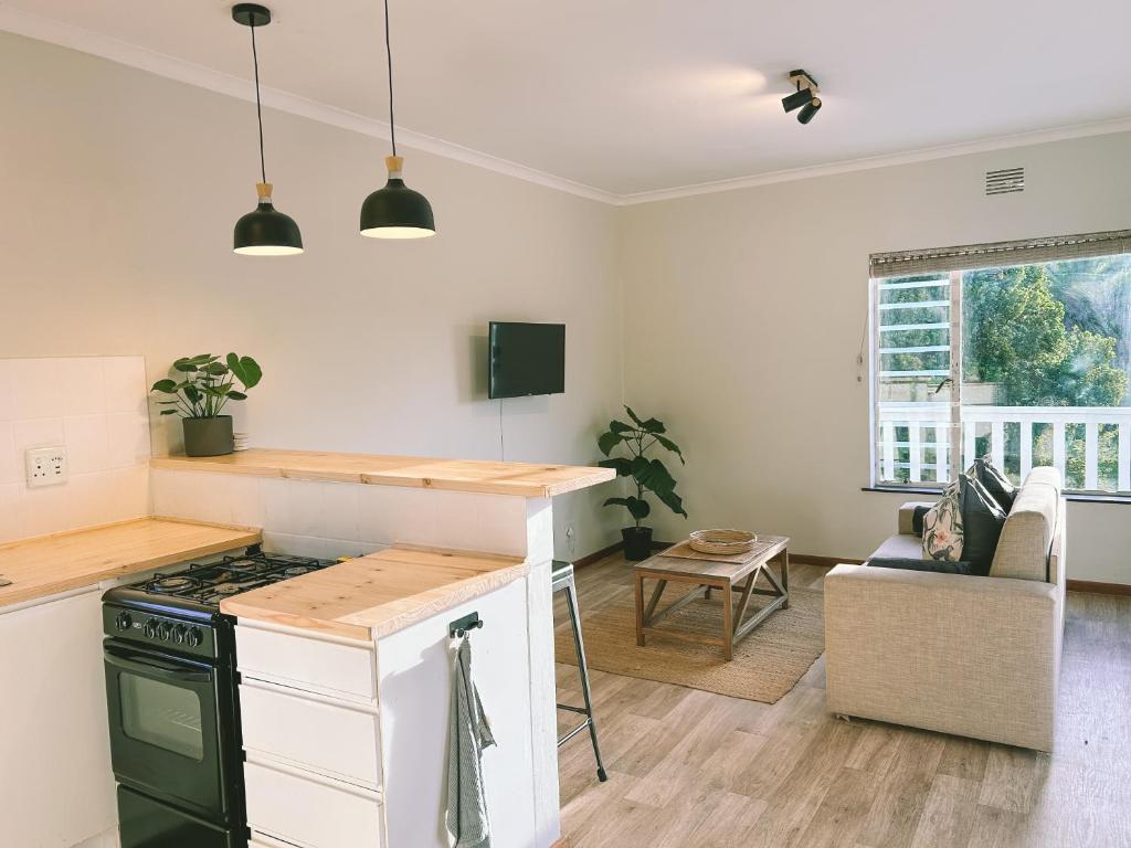 a kitchen with a stove and a counter top at Leisure Isle Loft Apartment in Knysna