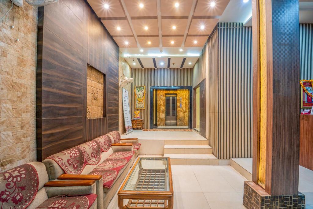 a hallway with couches and a table in a building at HOTEL AUGUSTO in Varanasi