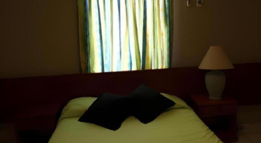 Postel nebo postele na pokoji v ubytování Curacao Lodge