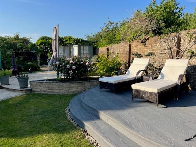 two chairs and a table on a patio at The Resting Shepherd in Angmering