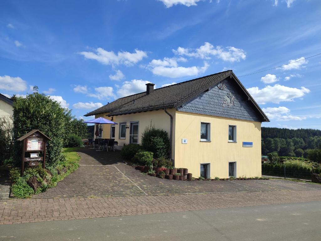 a large white house with a black roof at Ferienhaus Gönen in Bleialf