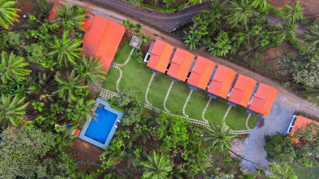 an overhead view of a park with palm trees at The Enchanted Nest By Privy Stays in Alibag