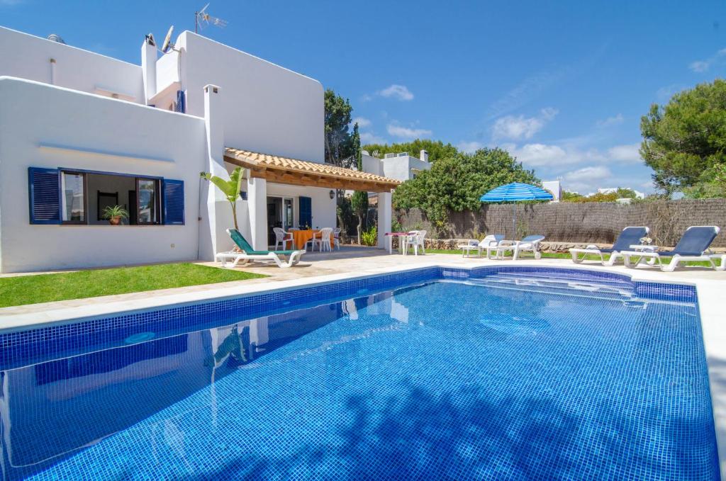 a villa with a swimming pool and a house at Villa Cala Esmeralda in Cala d´Or