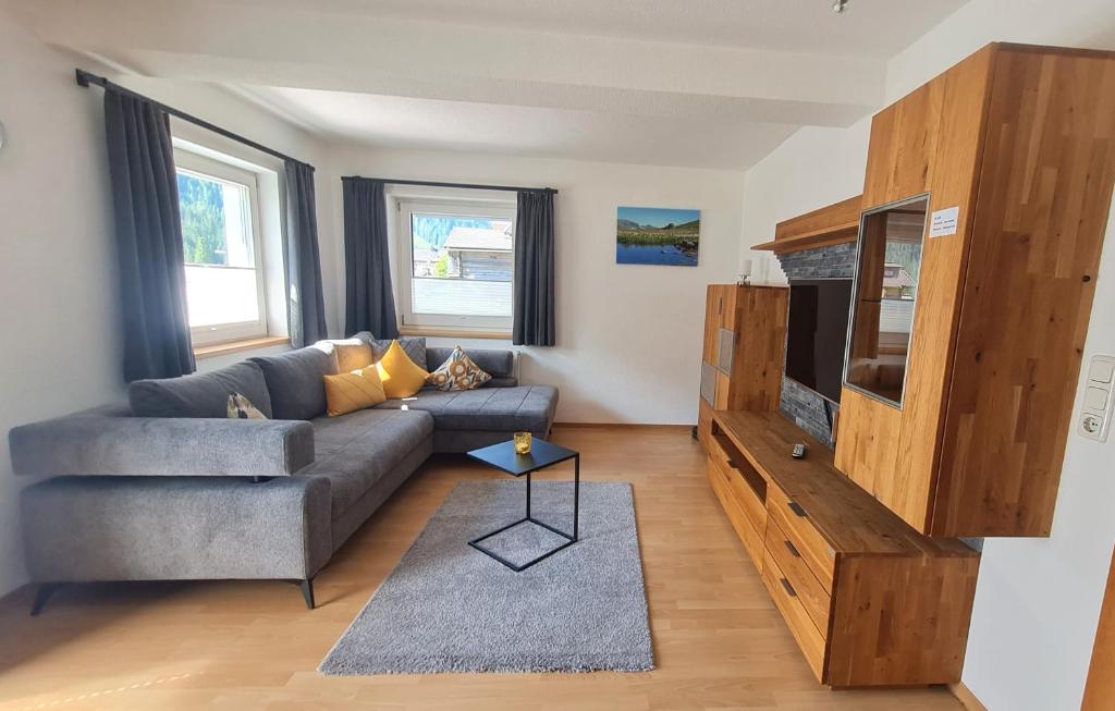 a living room with a couch and a tv at Haus Alpenheim Apartment 3 in Tux