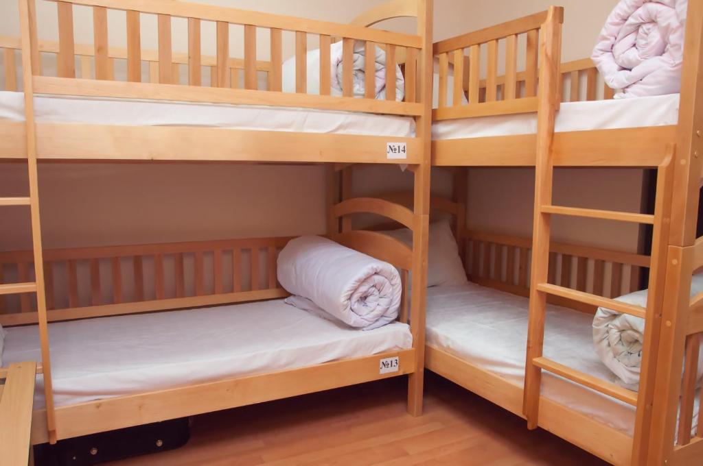 a bunk bed room with two bunk beds with white towels at Globus Hostel in Kyiv