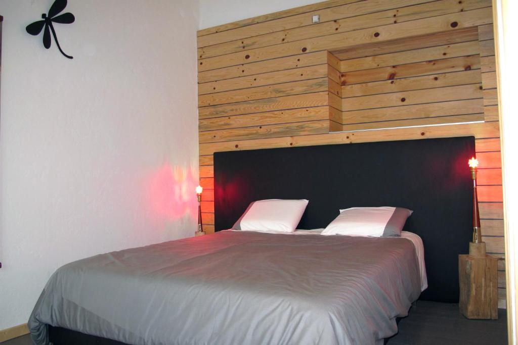 a bedroom with a large bed with a wooden headboard at Stone Station in Esneux