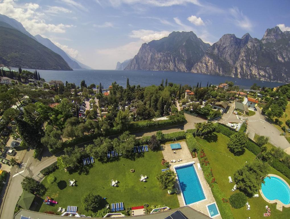 an aerial view of a resort with a lake and mountains at Residence Toblini in Nago-Torbole