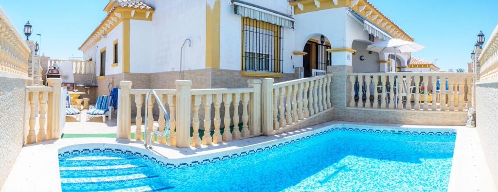 una casa con piscina frente a una casa en Casa Trudy en Torrevieja