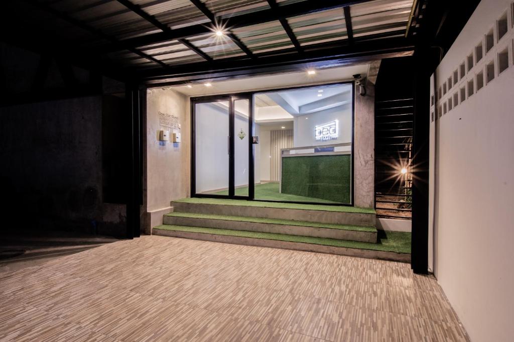 an empty hallway with a window and stairs in a building at Bed-room at Suvarnabhumi Airport -SHA- in Lat Krabang