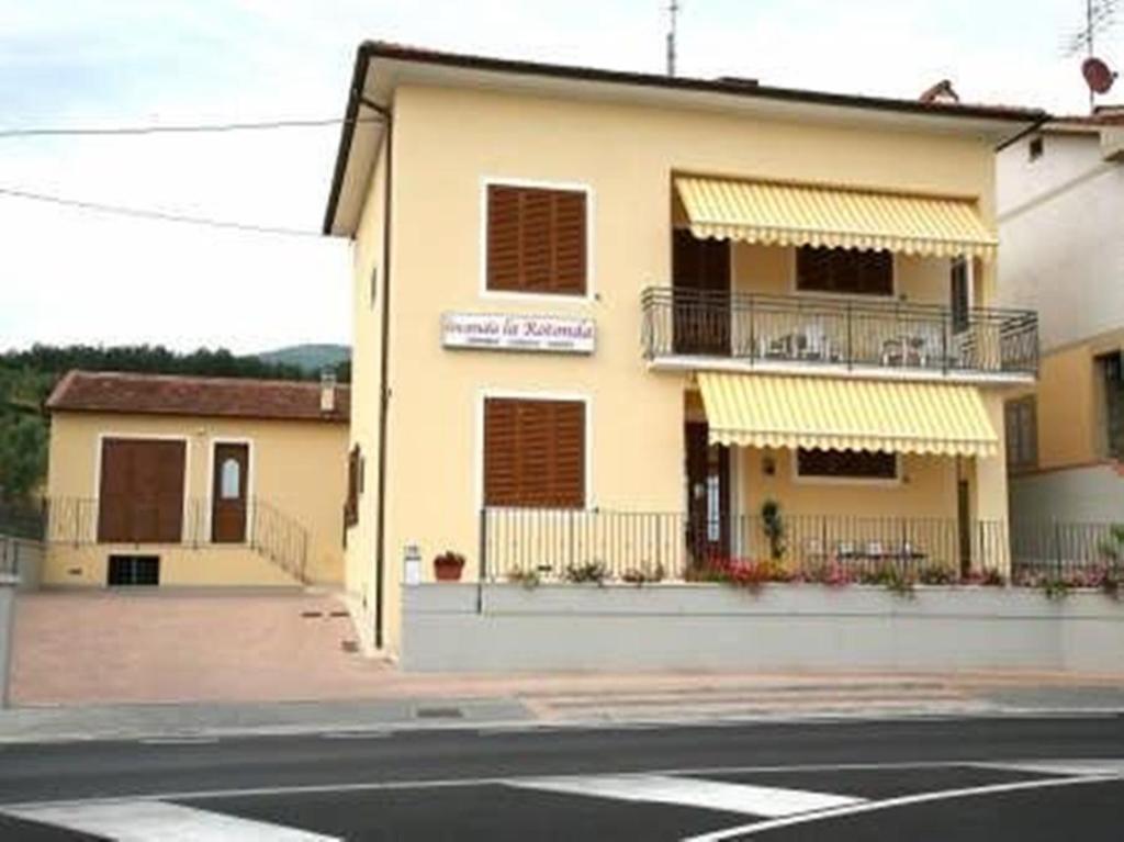 a building on the side of a street at B&B Locanda La Rotonda in Montale