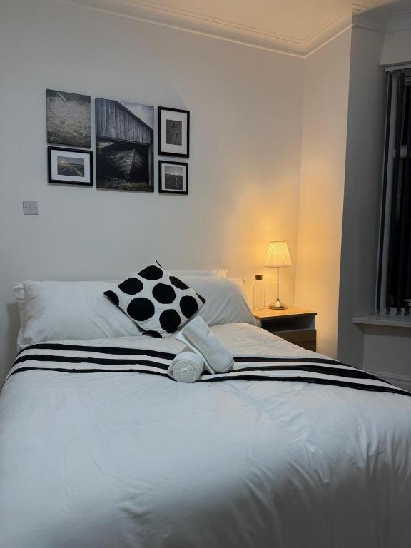 a bedroom with a bed with a teddy bear on it at Britlodge Ruskin Ave Home in Manchester