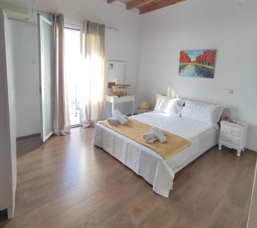 a bedroom with a large white bed with towels on it at Anna's Apartment in Gaios