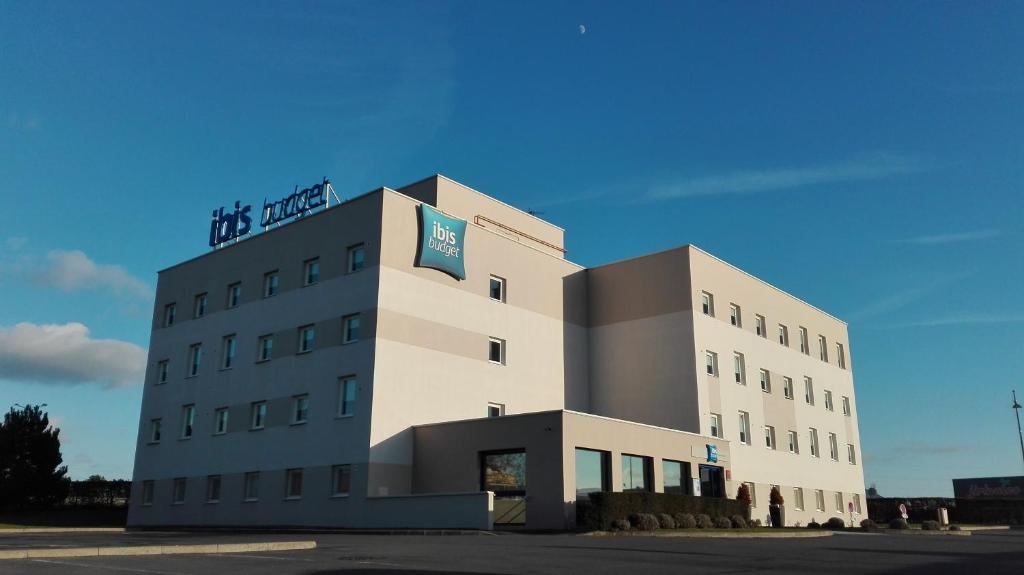 a building with a sign on top of it at ibis budget Reims Thillois in Reims