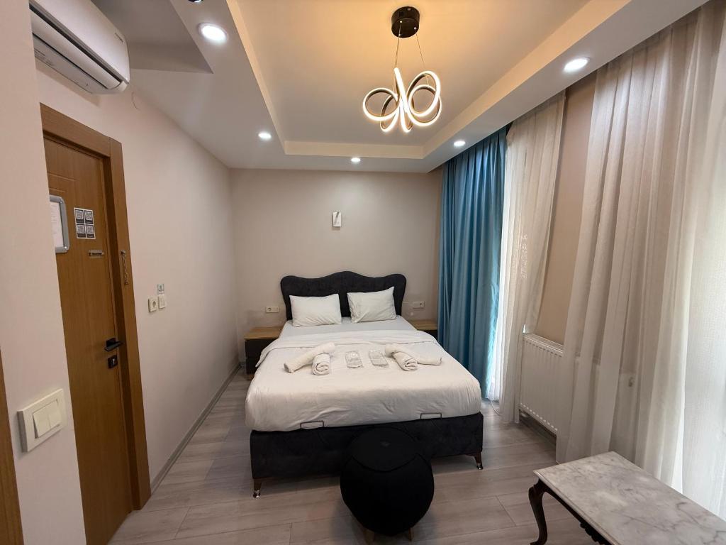 a bedroom with a bed and a chandelier at Koçyiğit Suite & Hotel in Istanbul