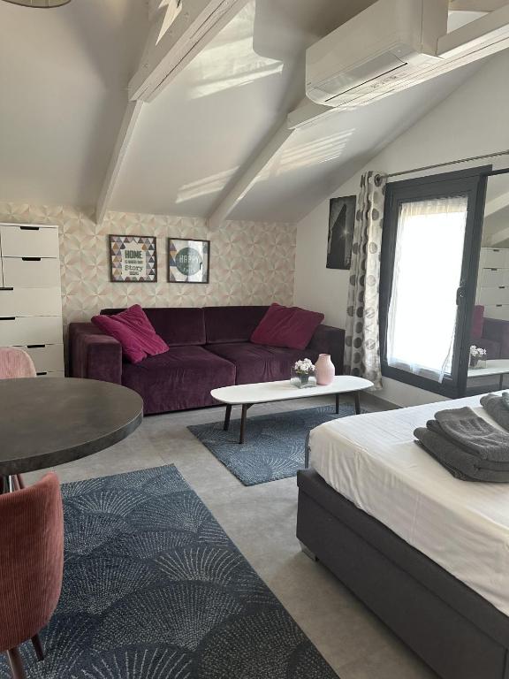 a living room with a couch and a table at Trendy studios Tassin in Tassin-la-Demi-Lune