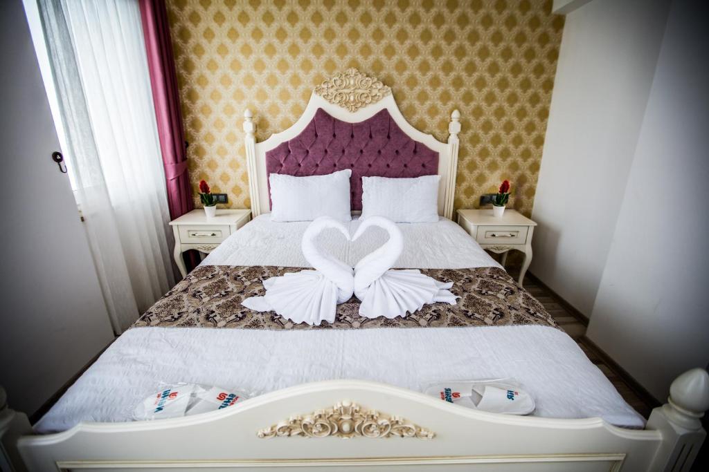 a bedroom with a bed with a heart decoration on it at Air Suite Hotel in Trabzon