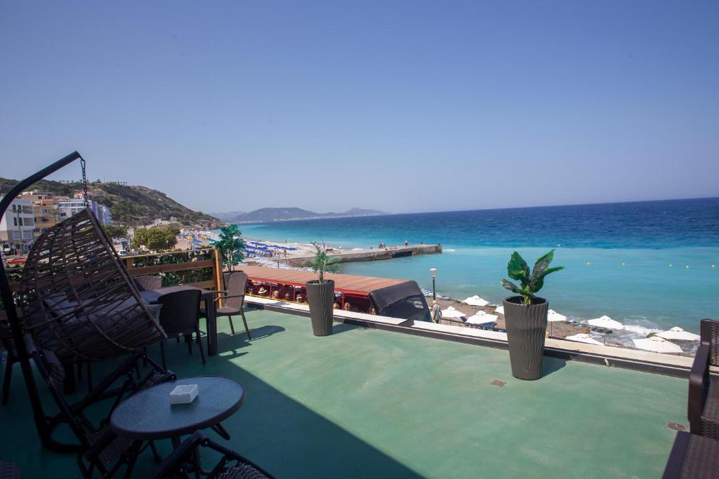 a balcony with a view of the ocean from a resort at Aegean Sunset Loft in Rhodes Town