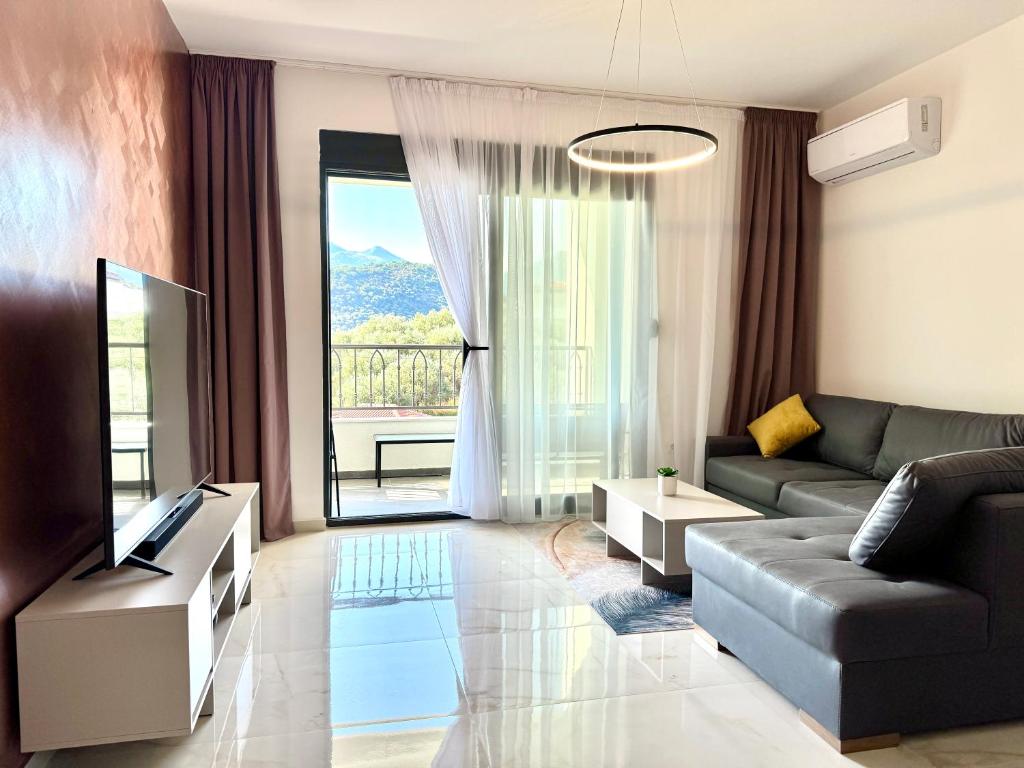a living room with a couch and a television at Apartment BAR M3A sea view in Bar