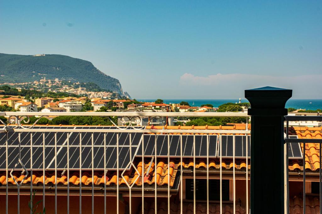 a balcony with a view of a city and the ocean at La Casa di Lucia in Marcelli