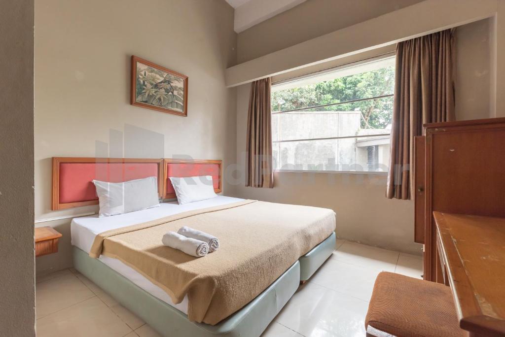 Giường trong phòng chung tại Hotel Wisma Dago ITB