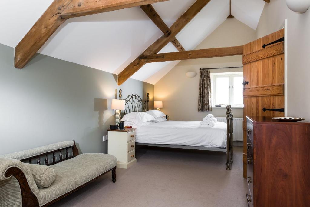 a bedroom with two beds and a window at The Old Bakery Sleeps 4 in Kingham