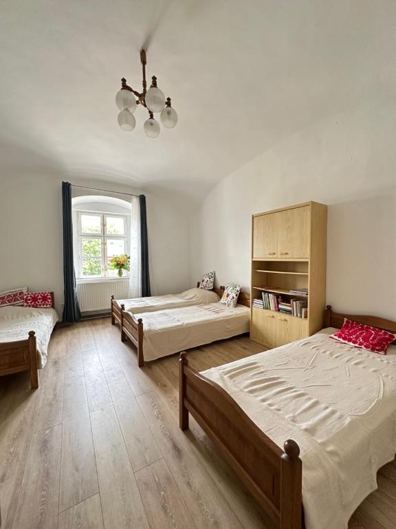 a bedroom with two beds and a window at Templomdomb apartman in Kővágóörs