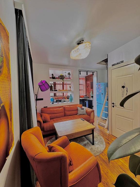 a living room with two couches and a table at Maria's Dream House On Vera in Tbilisi City