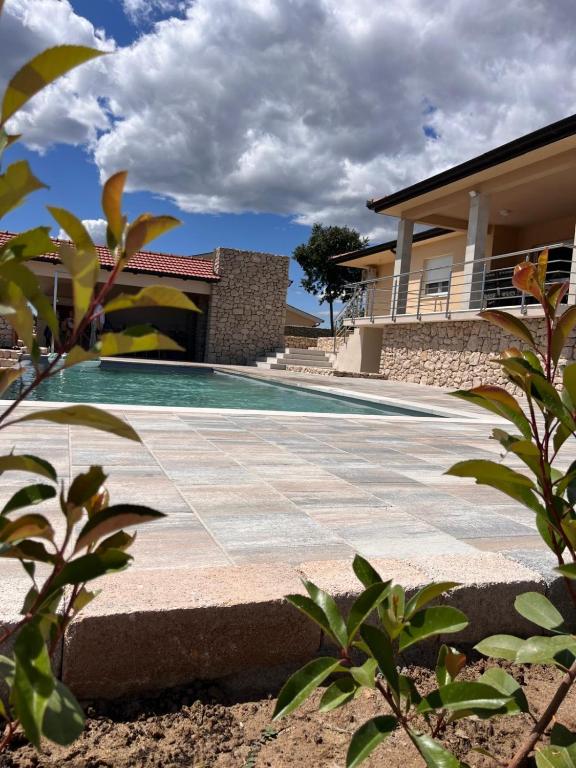 a swimming pool in front of a house at Villa Ruška in Ljubuški