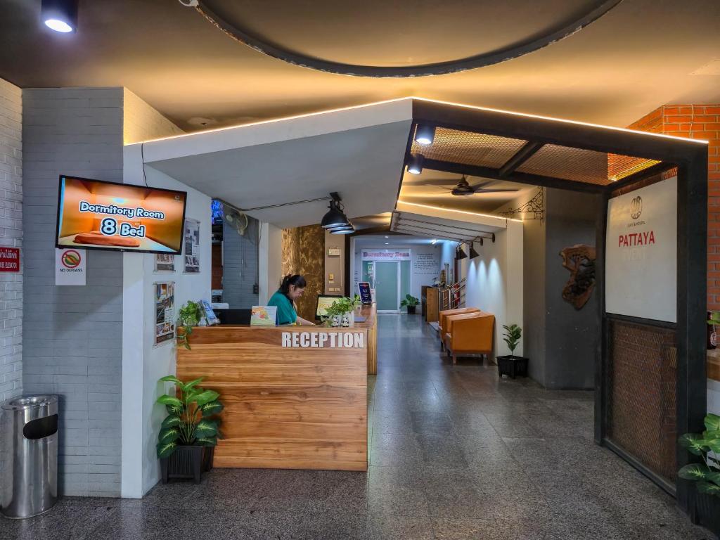 a restaurant with a reception desk in a building at 18 Coins Budget Hotel in Pattaya Central