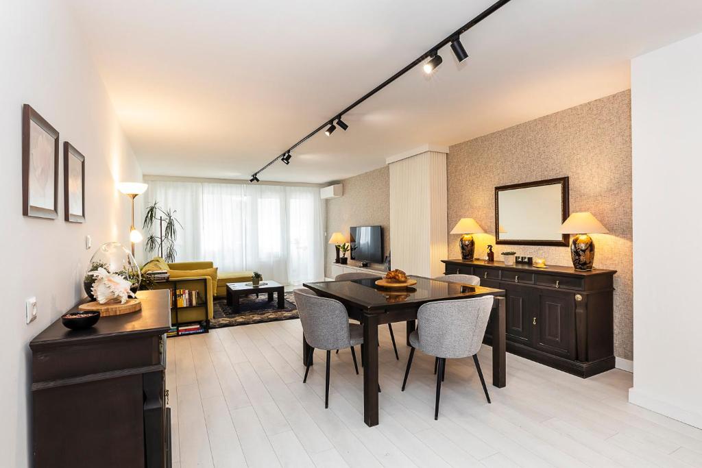 a living room with a table and chairs at D-home in Sofia