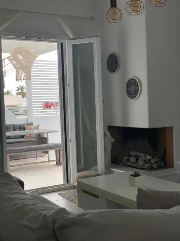 a living room with a couch and a fireplace at City center Paroikia apartment in Parikia