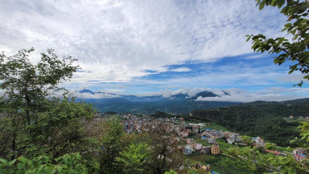 a view of a city with mountains in the distance at Hotel Sabaiko in Kathmandu