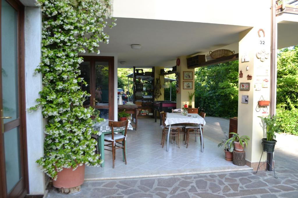 un patio con mesa, sillas y plantas en B&B La Casarella, en Soiano del Lago