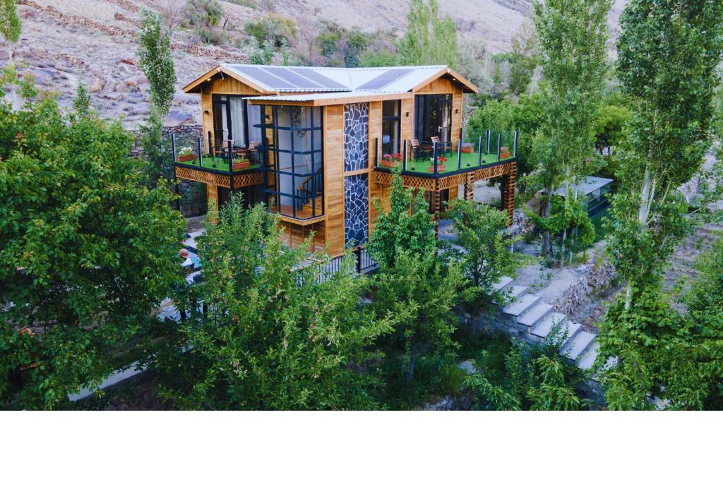 an aerial view of a house with trees at Firdaus Hotel & Resort in Alīābād