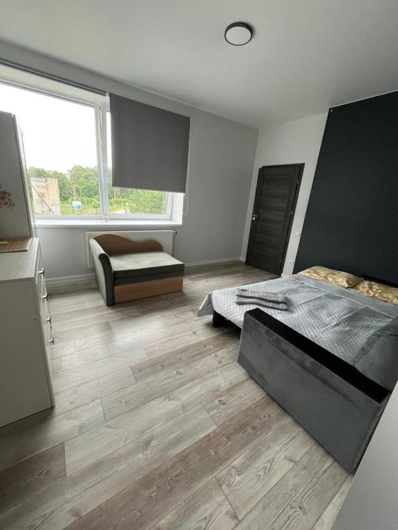 a bedroom with two beds and a window at 1 kambario apartamentai in Raseiniai