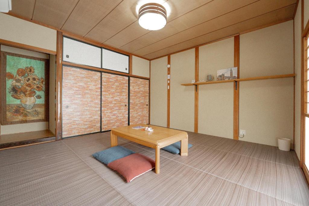 an empty room with a table and a window at Private lodging MOKUBA 