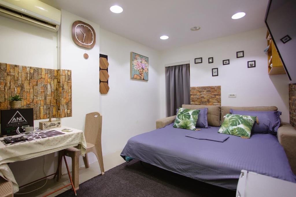 a bedroom with a bed and a desk and a table at Stay & Go room in Shkodër