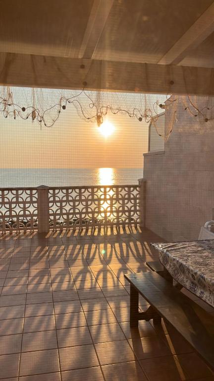 a room with a table and a bench on a patio at Casa delle Onde in San Vito